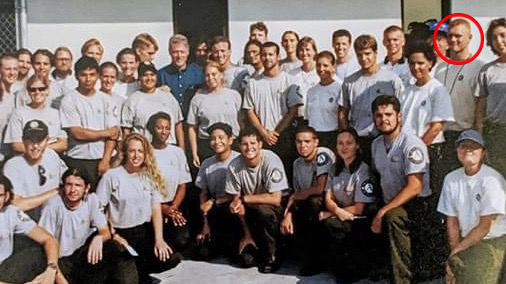 Joshua with his team and Bill Clinton